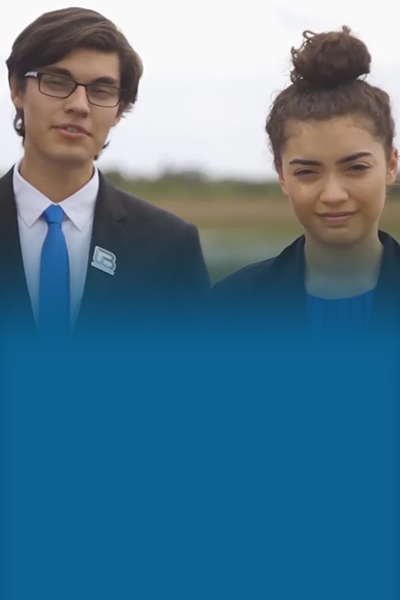 BTN 400×600 Two teen reporters male and female outdoors looking at camera