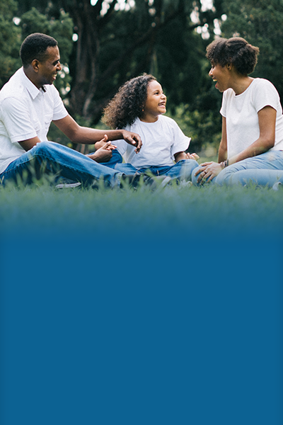 Future First 400×600 Man woman and child sitting in a field outdoors smiling at one another