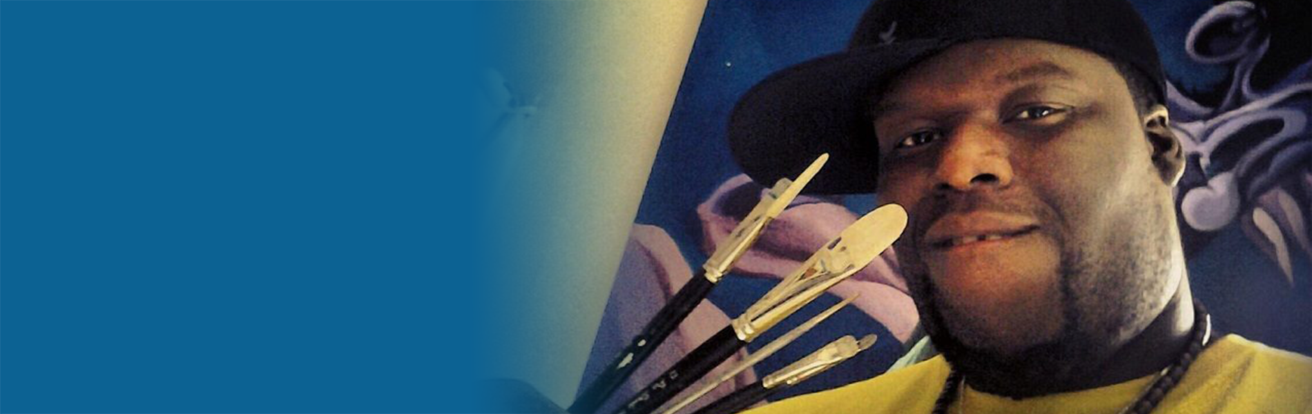 New_Haitian_1900x600 Haitian artist holding paint brushes
