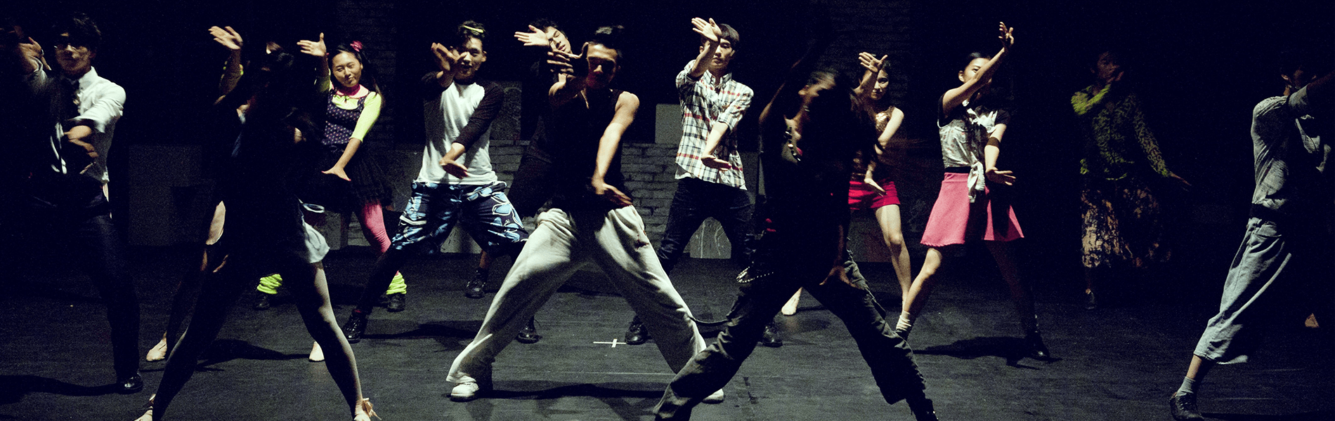 Spotlight on the Arts 1900×600 Young performers on stage dancing in plain clothing